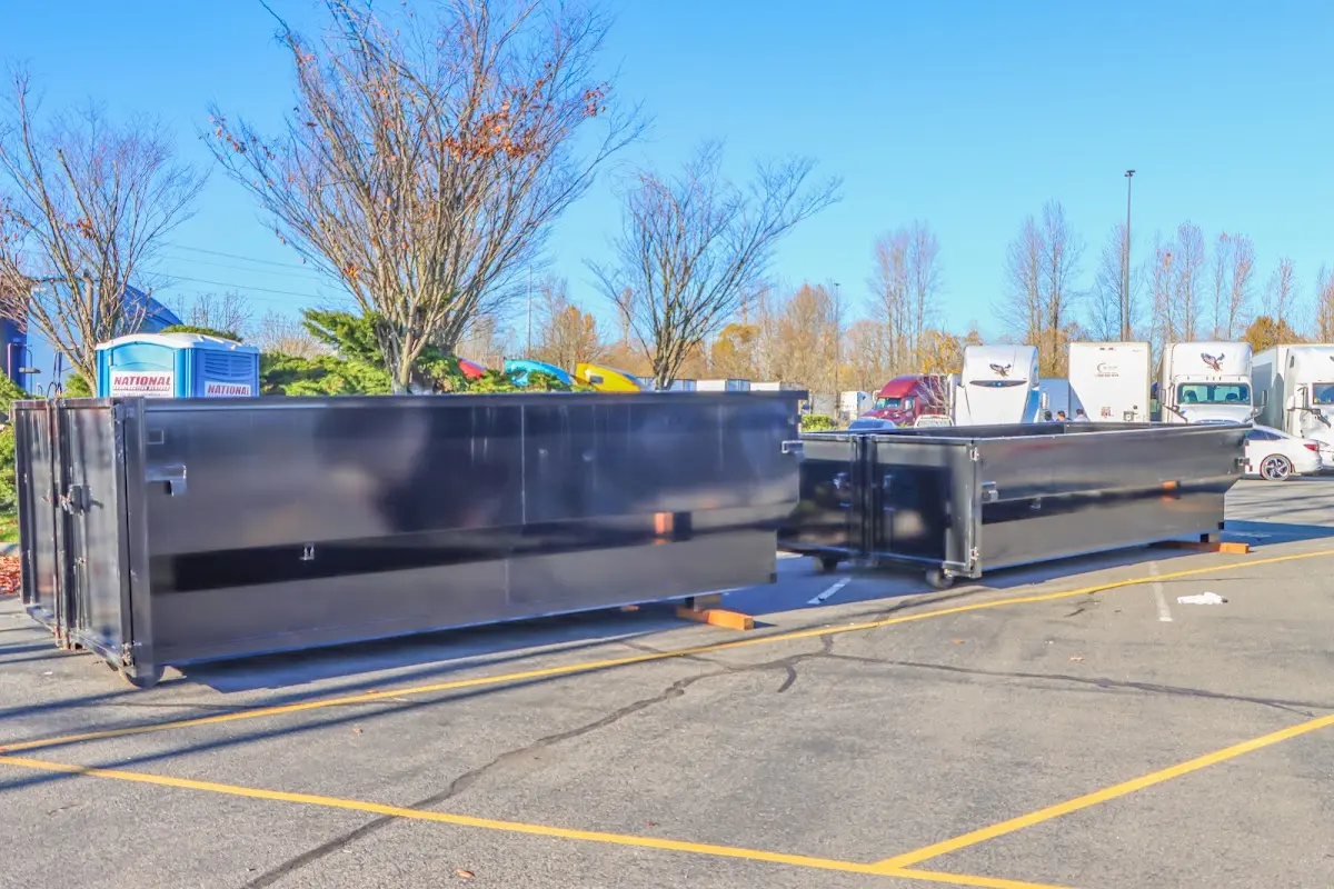 Professional dumpster rental service with roll-off container on residential driveway in Grimes